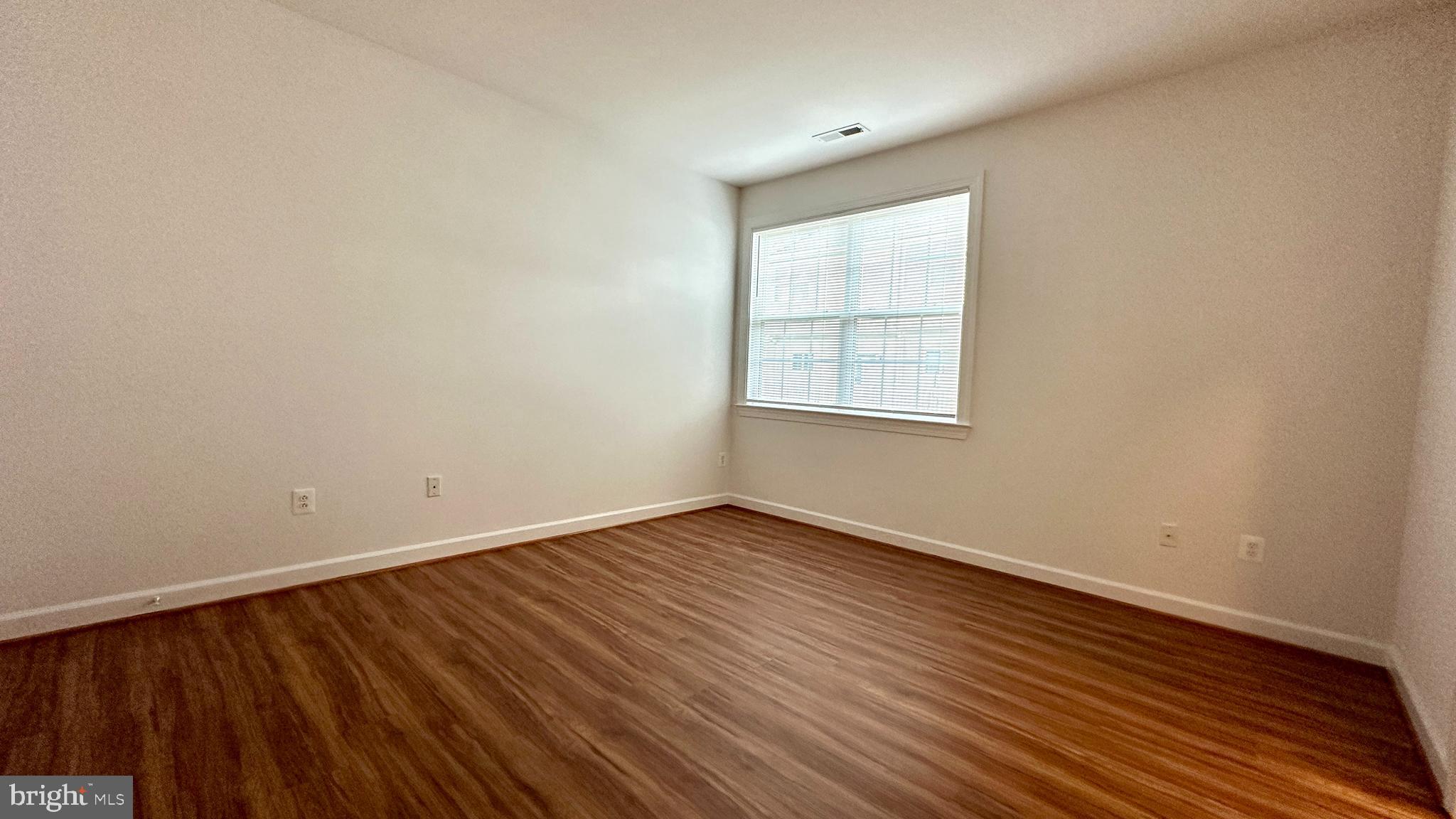 14020 Castle Ridge Way, Unit 38 Silver Spring, MD 20904 - Photo 14 of 30 an empty room with wooden floor and windows