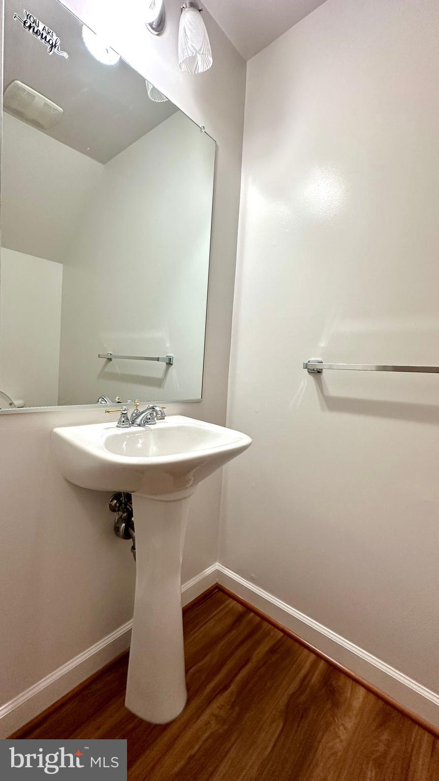 14020 Castle Ridge Way, Unit 38 Silver Spring, MD 20904 - Photo 23 of 30 a bathroom with a sink a mirror and wooden floor