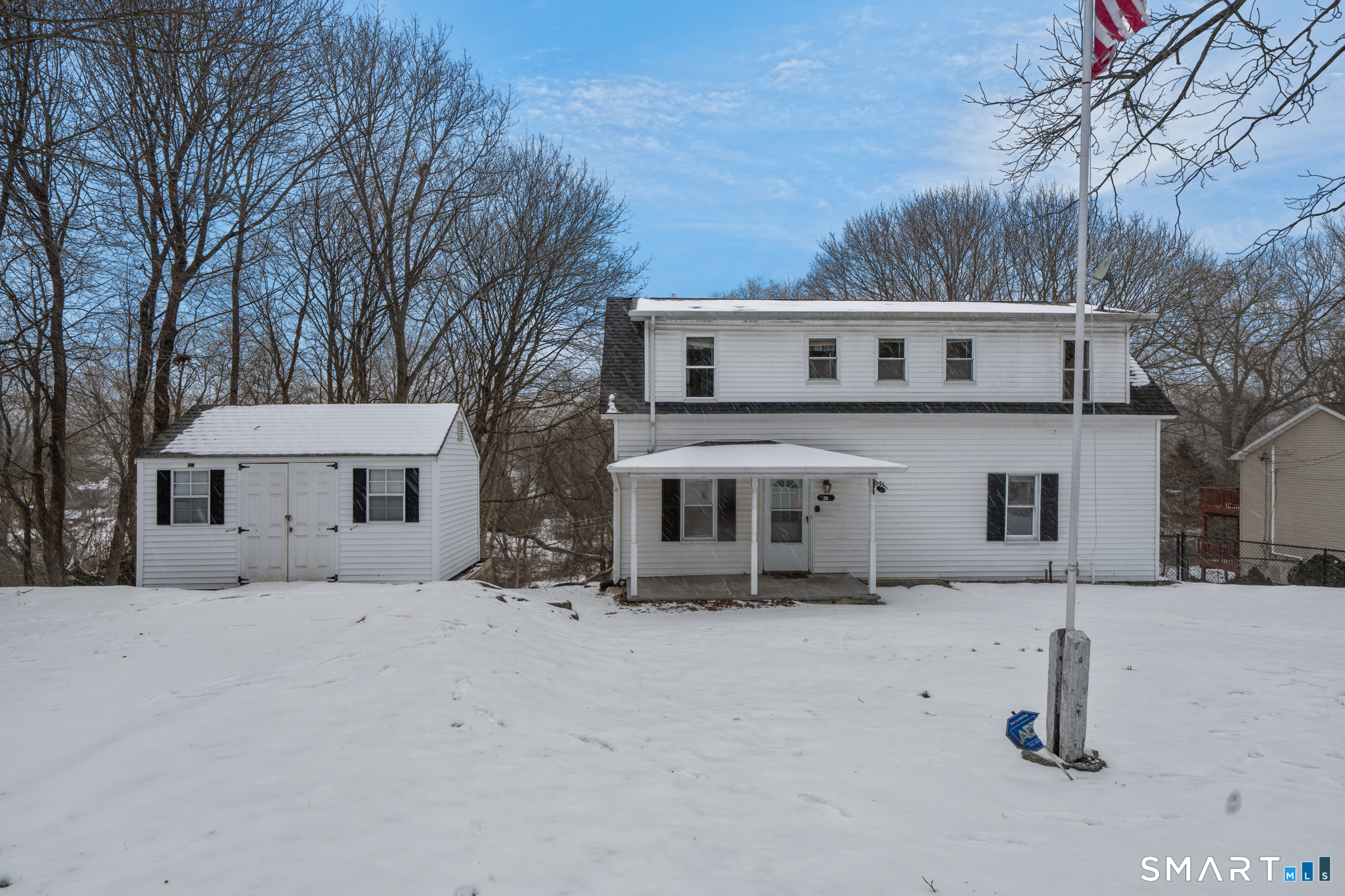 a view of a house with a snow in the yard