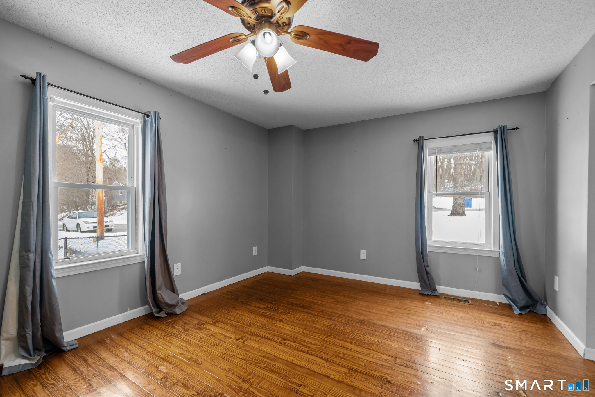 30 Ruth Street Norwich, CT 06360 - Photo 14 of 40 an empty room with wooden floor and windows