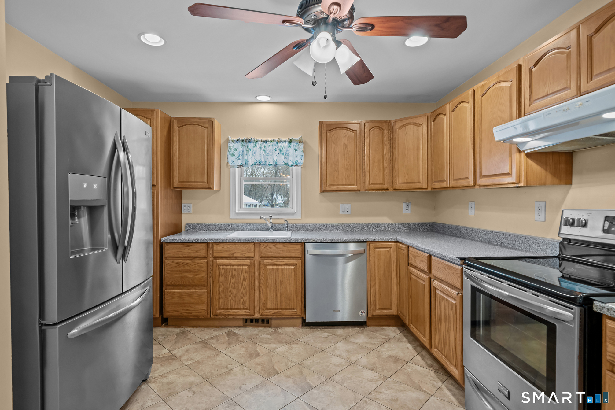 30 Ruth Street Norwich, CT 06360 - Photo 15 of 40 a kitchen with stainless steel appliances granite countertop a refrigerator a stove a sink and a microwave