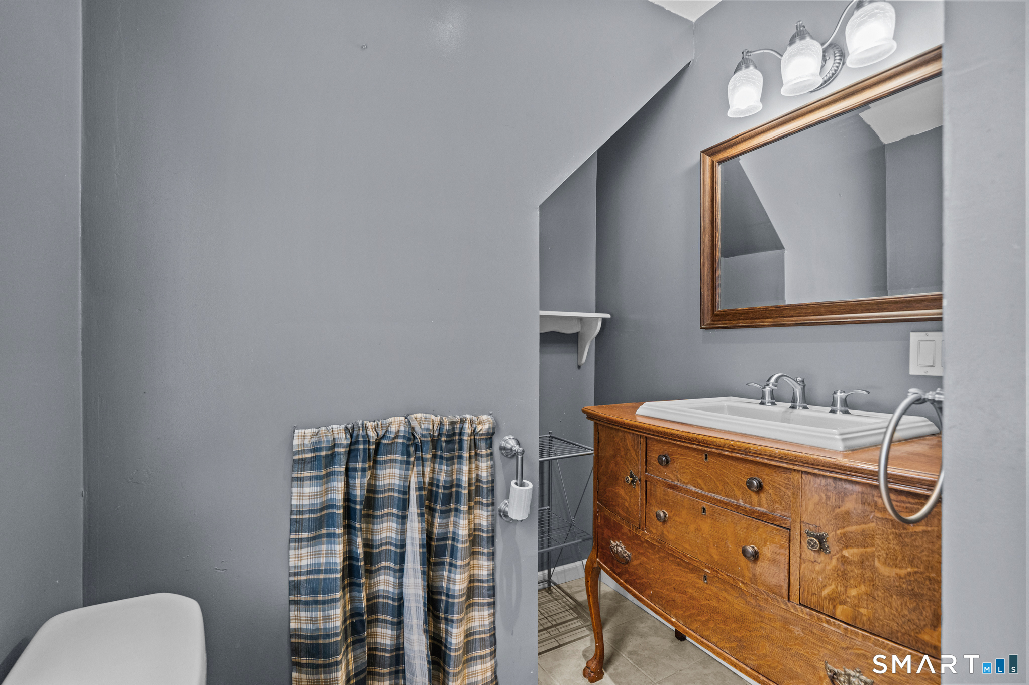 30 Ruth Street Norwich, CT 06360 - Photo 33 of 40 a bathroom with a toilet a sink and mirror