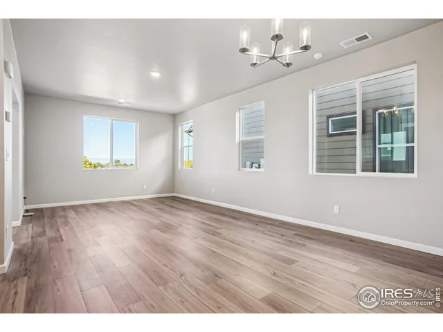 a view of kitchen with wooden floor and electronic appliances