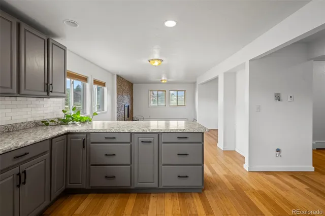 a kitchen with granite countertop a sink and cabinets