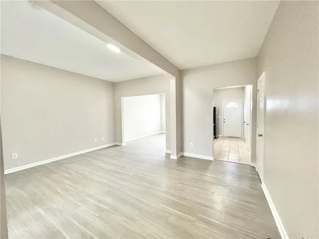 a view of an empty room and wooden floor