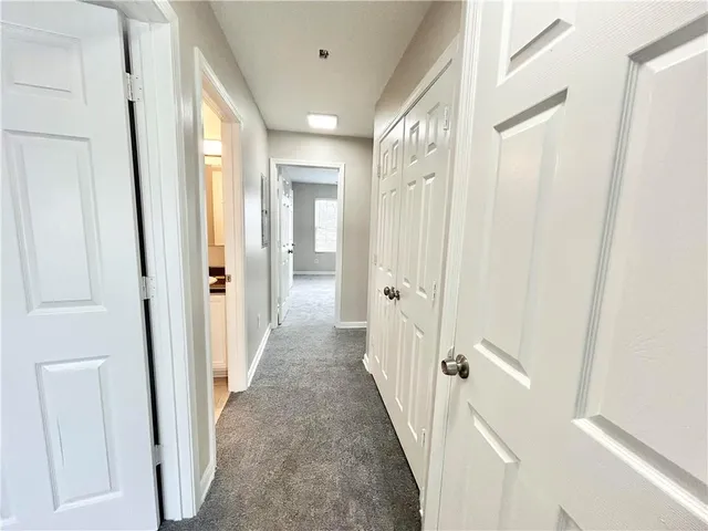 a view of a hallway with a door and staircase