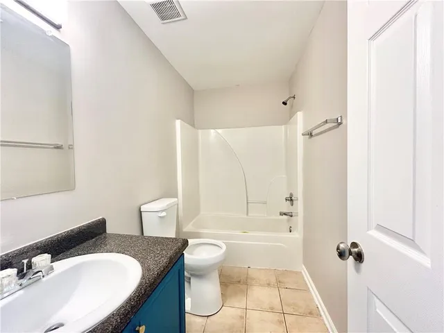 a bathroom with a sink toilet tub and shower