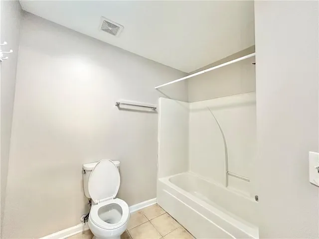 a bathroom with a toilet and a bathtub