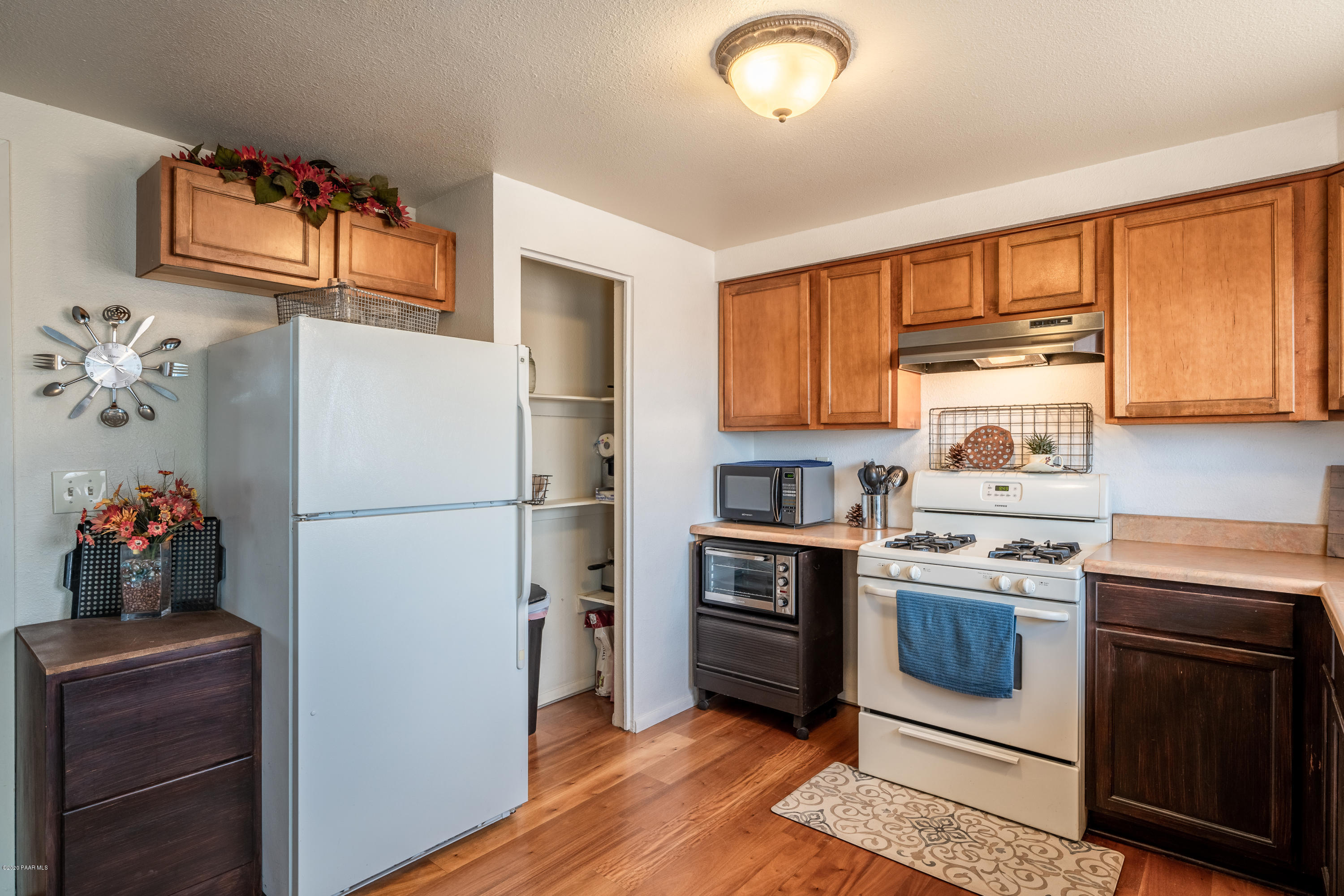 700 Ranch House Road Paulden, AZ 86334 - Photo 14 of 26 a kitchen with a refrigerator and white cabinets