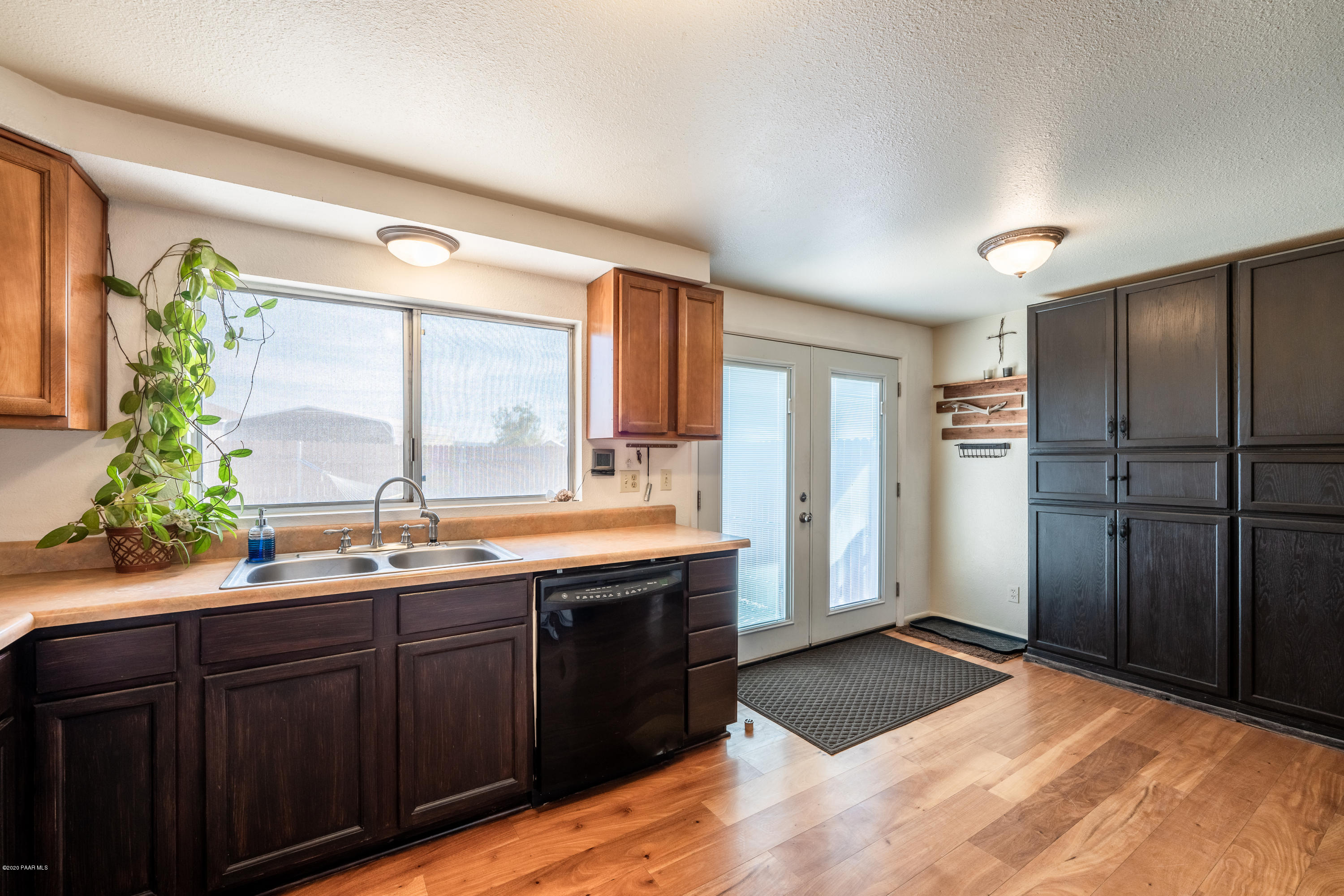700 Ranch House Road Paulden, AZ 86334 - Photo 15 of 26 a view of a sink a refrigerator and wooden cabinets