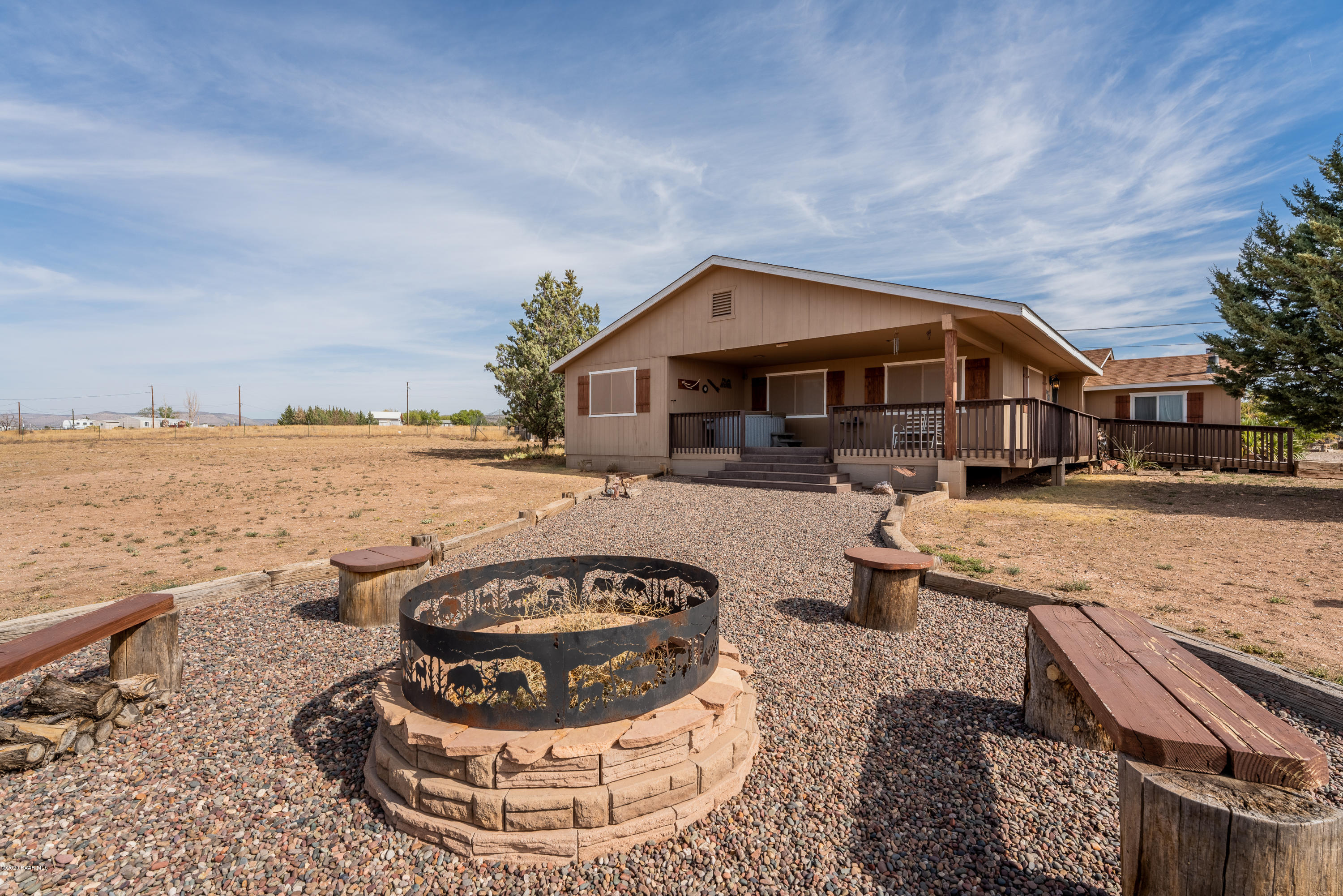 700 Ranch House Road Paulden, AZ 86334 - Photo 6 of 26 a view of a terrace with a barbeque and wooden fence