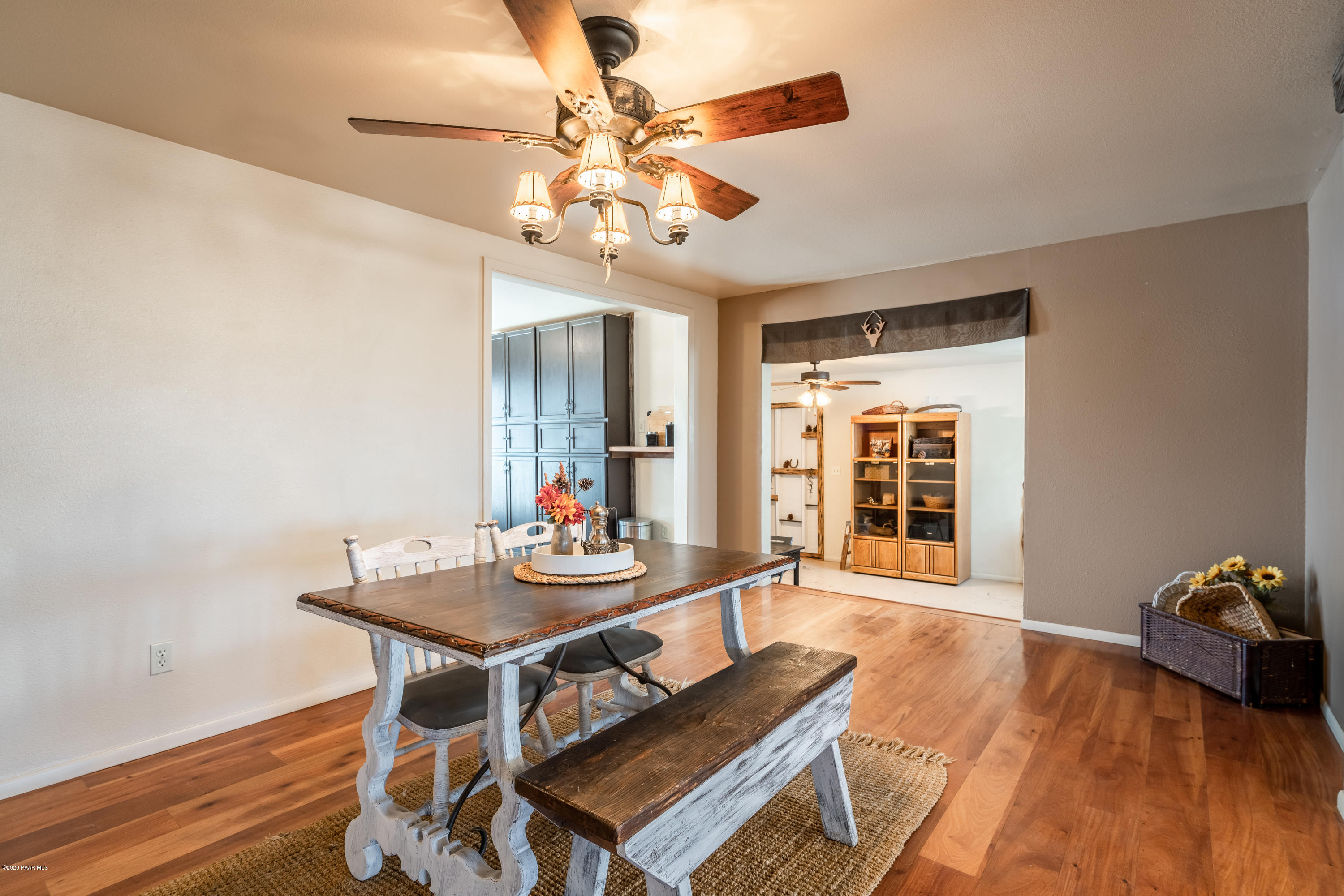 700 Ranch House Road Paulden, AZ 86334 - Photo 10 of 26 a view of a dining room with furniture a chandelier and wooden floor