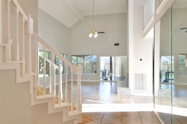 a living room with stainless steel appliances kitchen island granite countertop a refrigerator and a stove top oven