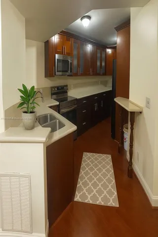 a kitchen with sink and cabinets