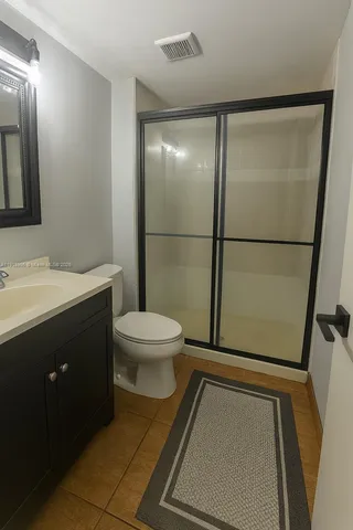 a bathroom with a toilet a sink and a mirror
