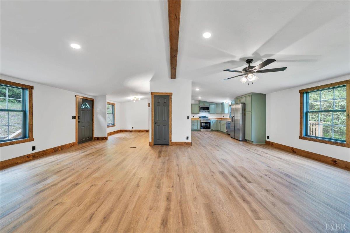 2781 Johnson School Road Thaxton, VA 24174 - Photo 22 of 63 a view of a livingroom with wooden floor and a ceiling fan