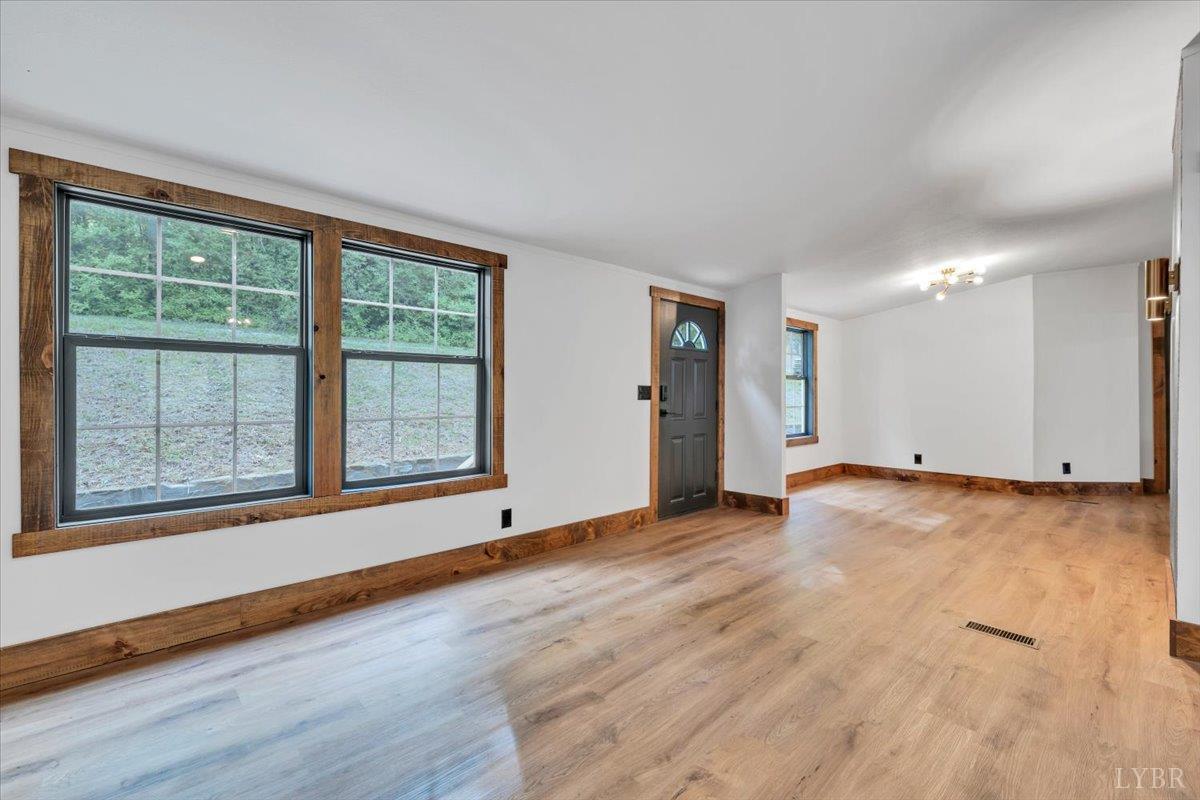 2781 Johnson School Road Thaxton, VA 24174 - Photo 25 of 63 a view of an empty room with wooden floor and a window