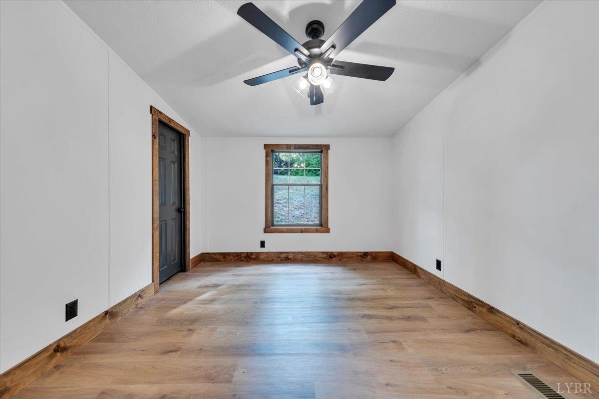 2781 Johnson School Road Thaxton, VA 24174 - Photo 34 of 63 an empty room with windows and ceiling fan