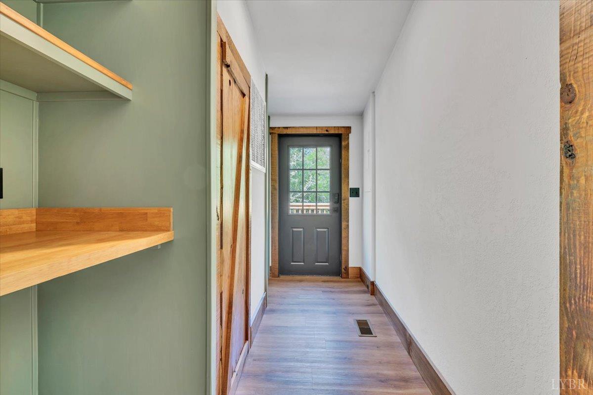 2781 Johnson School Road Thaxton, VA 24174 - Photo 45 of 63 a view of a hallway with wooden floor