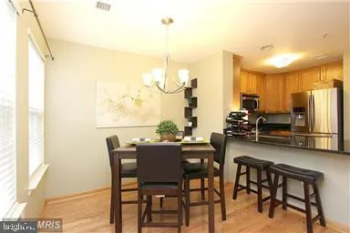 a view of a dining room with furniture a chandelier and wooden floor