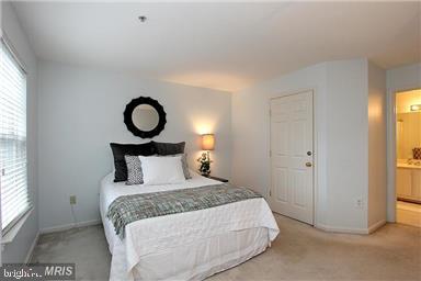 11864 Breton Court, Unit 14A Reston, VA 20191 - Photo 16 of 26 a bedroom with a bed and a window