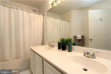 11864 Breton Court, Unit 14A Reston, VA 20191 - Photo 18 of 26 a bathroom with a sink and a mirror