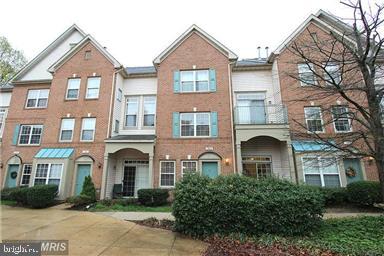 11864 Breton Court, Unit 14A Reston, VA 20191 - Photo 2 of 26 a front view of a house with garden