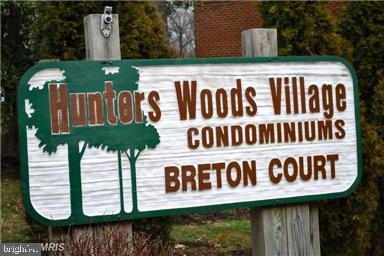 11864 Breton Court, Unit 14A Reston, VA 20191 - Photo 24 of 26 a sign on the side of a building
