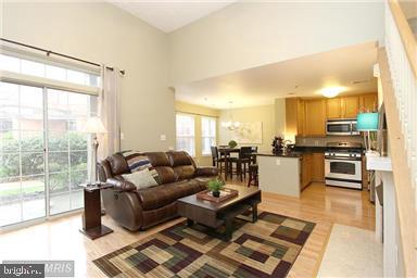 11864 Breton Court, Unit 14A Reston, VA 20191 - Photo 5 of 26 a living room with furniture and a view of kitchen