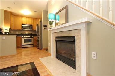 11864 Breton Court, Unit 14A Reston, VA 20191 - Photo 6 of 26 a kitchen with stainless steel appliances a stove and a microwave