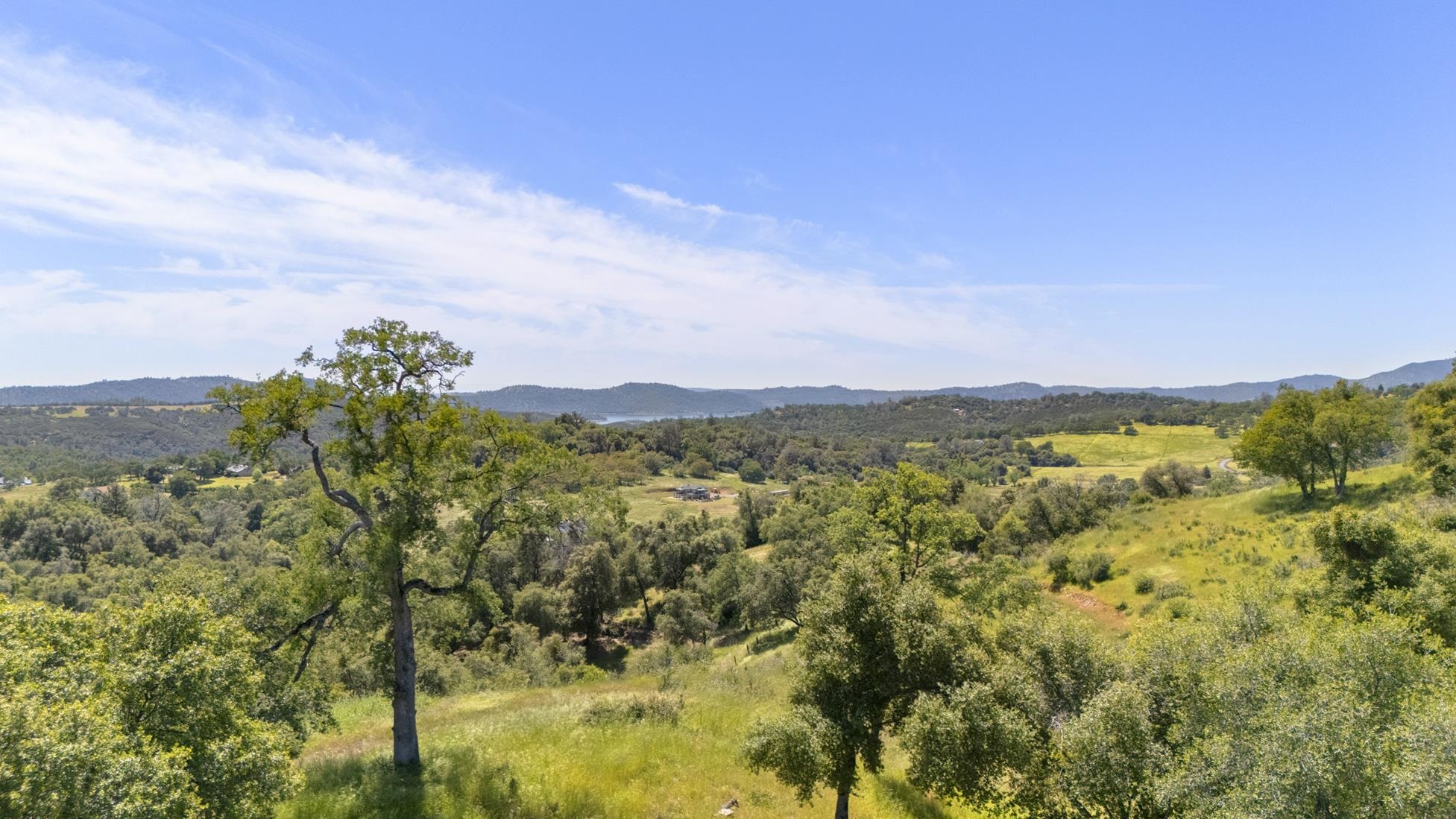 9082 Fraguero Road Sonora, CA 95370 - Photo 1 of 12 a view of a city with lush green forest