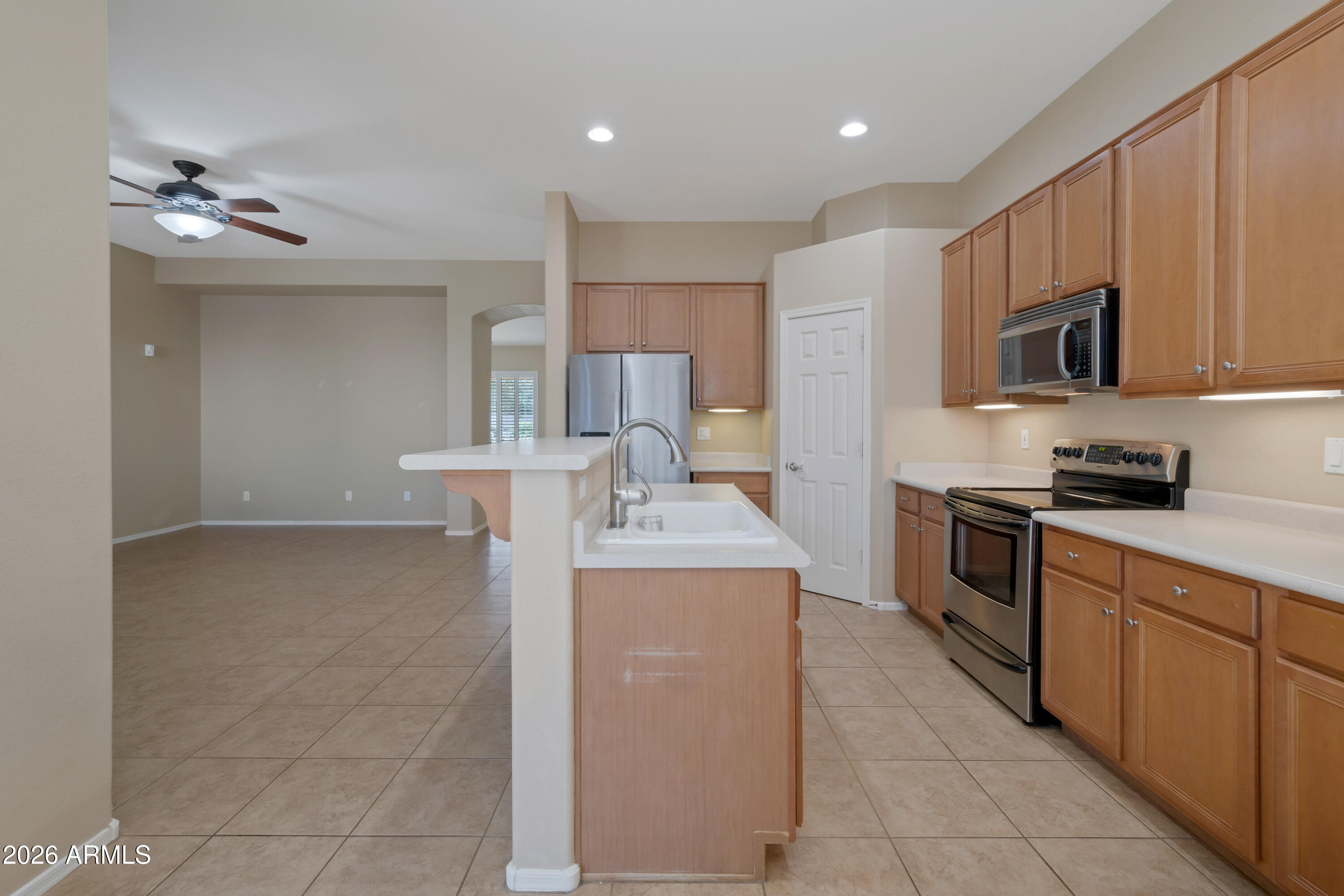 1912 East Flintlock Way Chandler, AZ 85286 - Photo 15 of 34 a kitchen with kitchen island a sink stainless steel appliances and cabinets