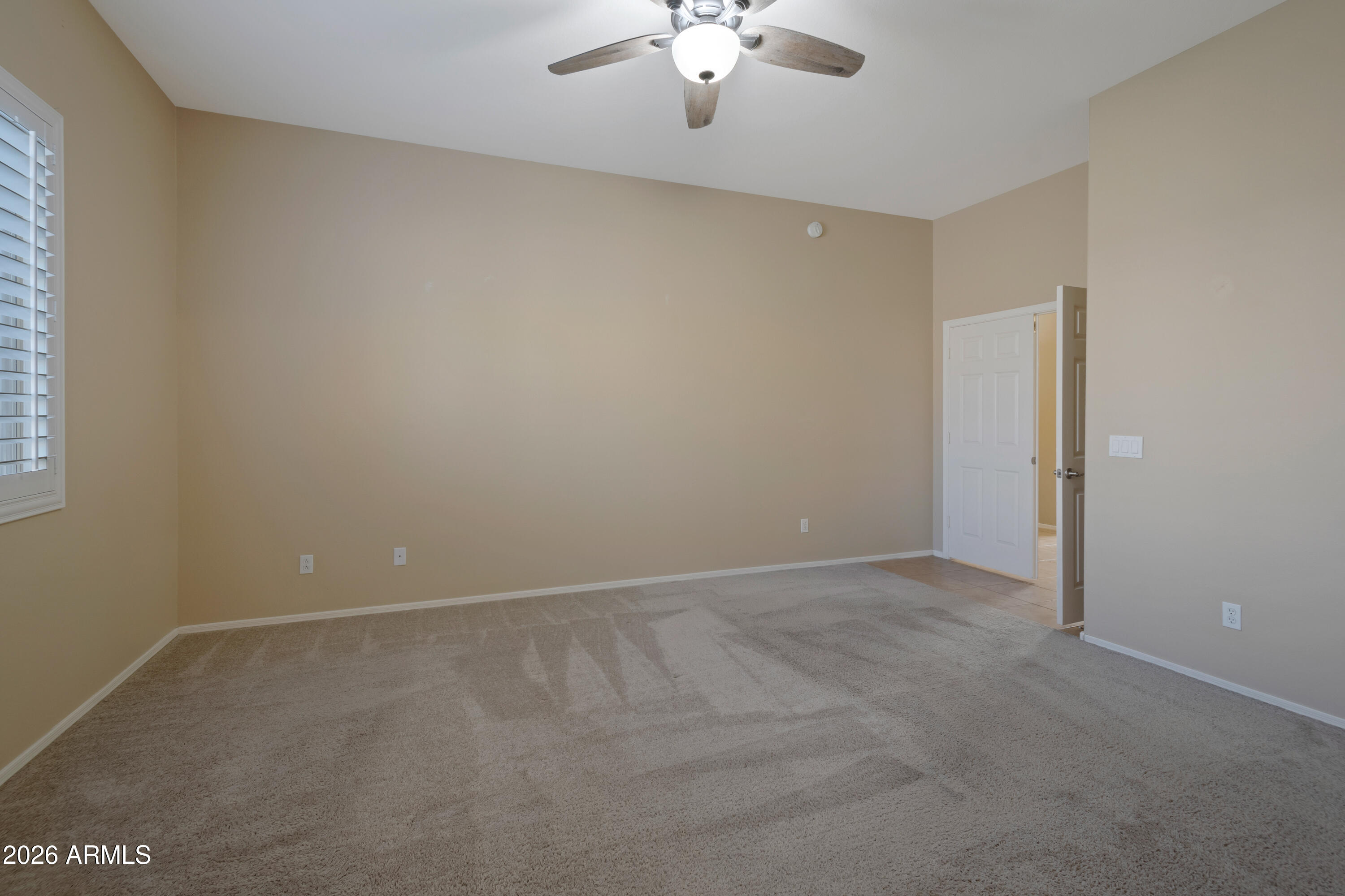 1912 East Flintlock Way Chandler, AZ 85286 - Photo 18 of 34 an empty room with a chandelier fan and windows