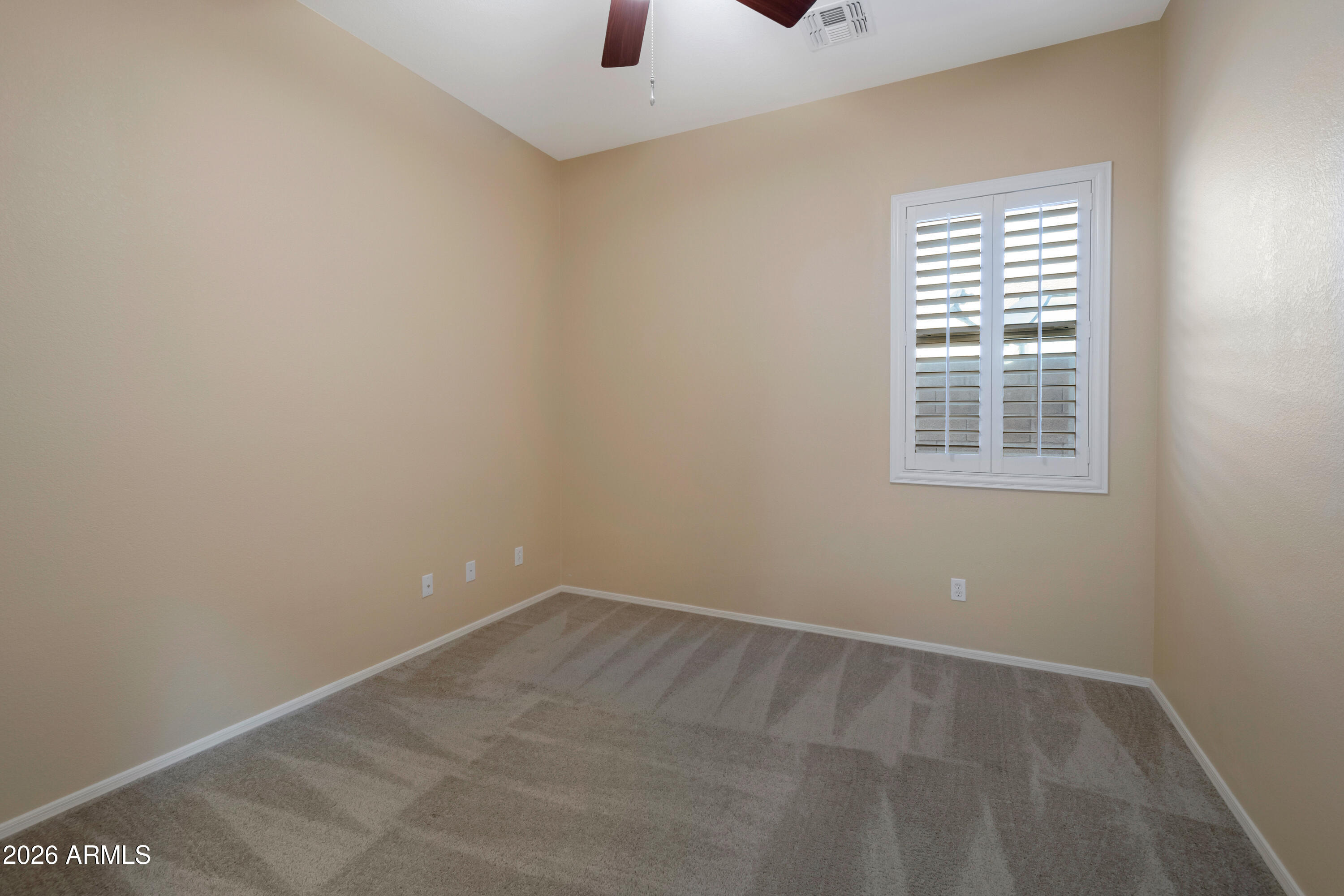 1912 East Flintlock Way Chandler, AZ 85286 - Photo 24 of 34 an empty room with a window and a fan