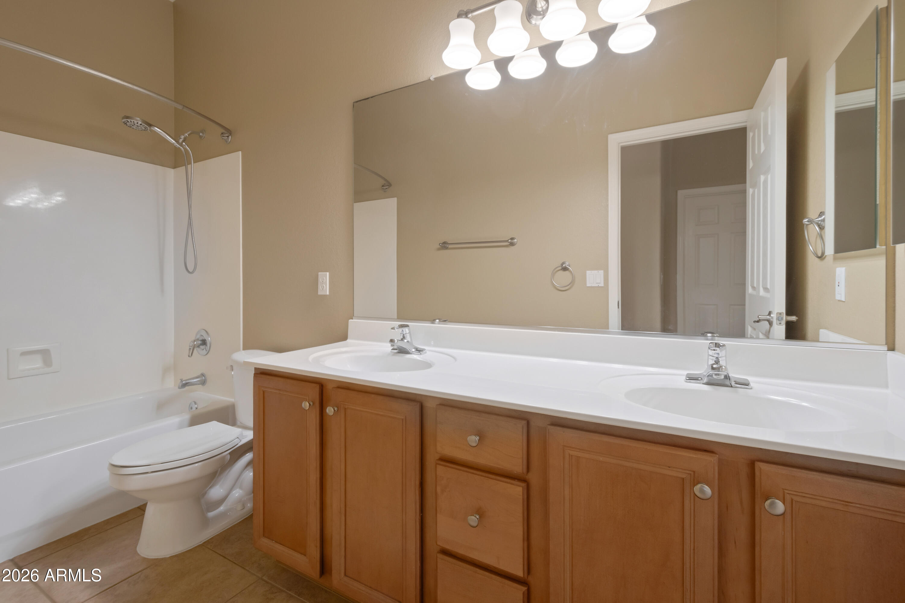 1912 East Flintlock Way Chandler, AZ 85286 - Photo 26 of 34 a bathroom with a sink a toilet and a large mirror