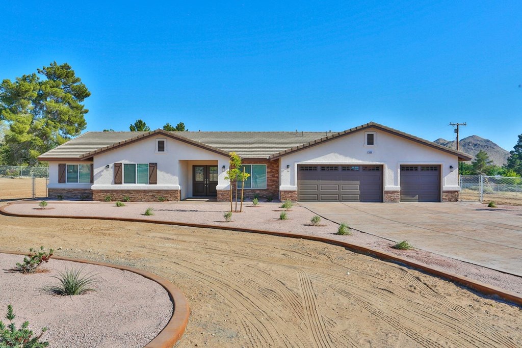16522 Muni Road Apple Valley, CA 92307 - Photo 1 of 1 a white house with a large yard and wooden fence