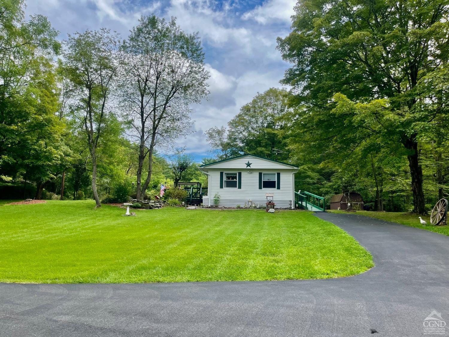 83 Ufferts Road Catskill, NY 12414 - Photo 29 of 29 a house that is sitting in middle of grass and trees in the background