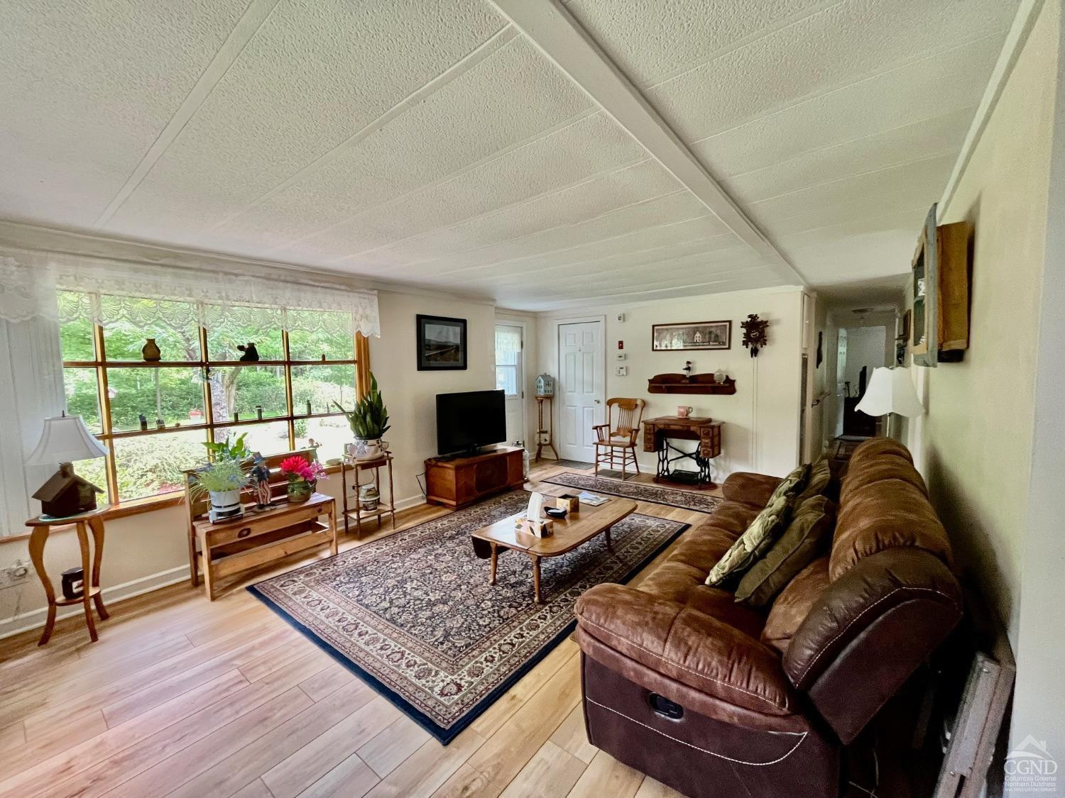 83 Ufferts Road Catskill, NY 12414 - Photo 4 of 29 a living room with furniture and a flat screen tv