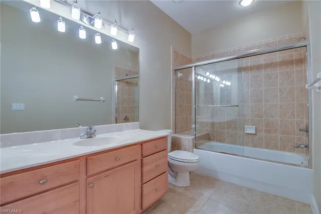 a bathroom with a bathtub shower sink vanity and toilet