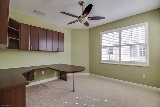 a view of a livingroom with furniture and a window