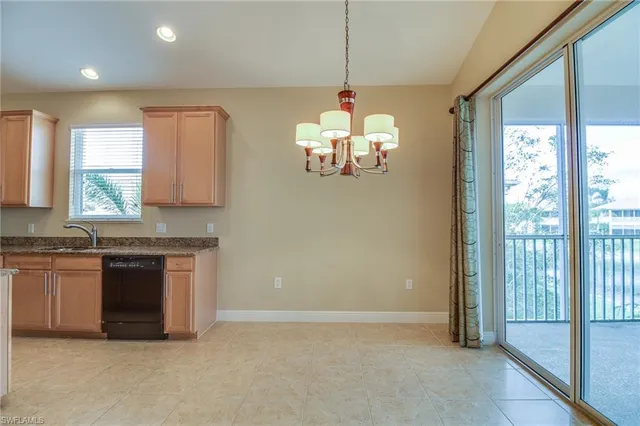 a kitchen with stainless steel appliances granite countertop a stove and a chandelier