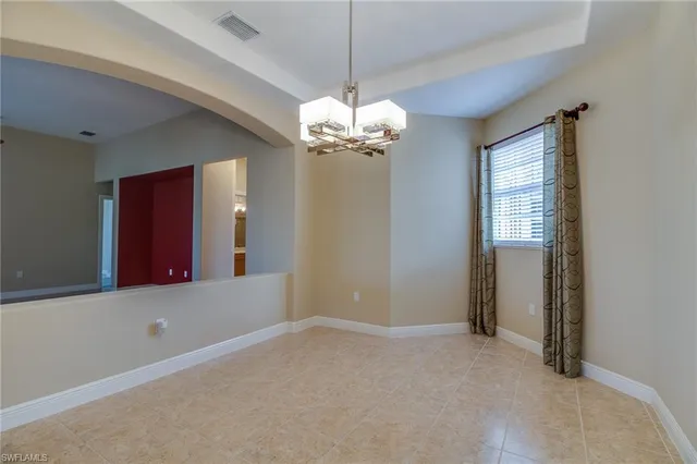 a view of a chandelier in big room and chandelier fan