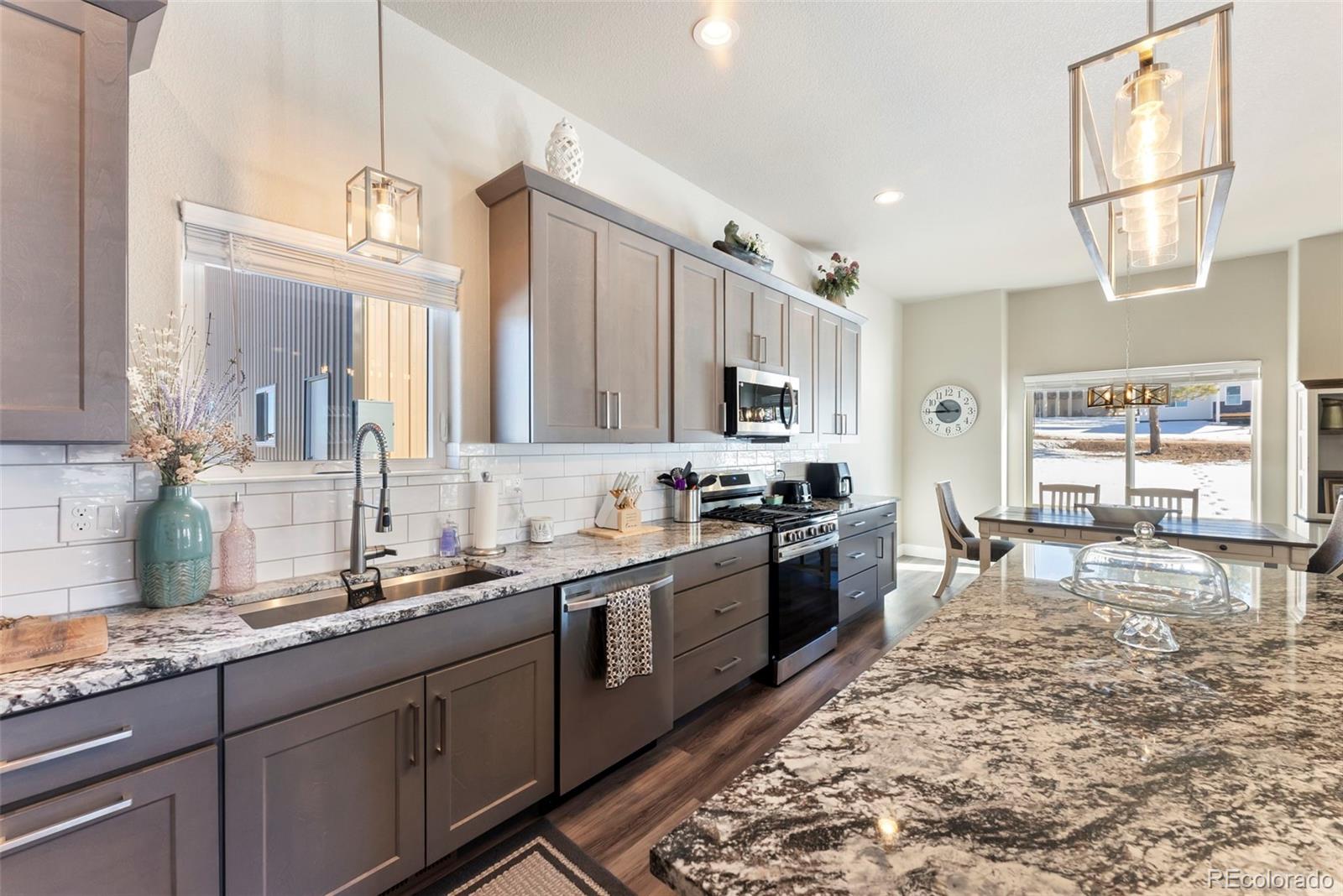489 Duesouth Road Florissant, CO 80816 - Photo 12 of 45 a large kitchen with granite countertop a sink and dishwasher stove top oven
