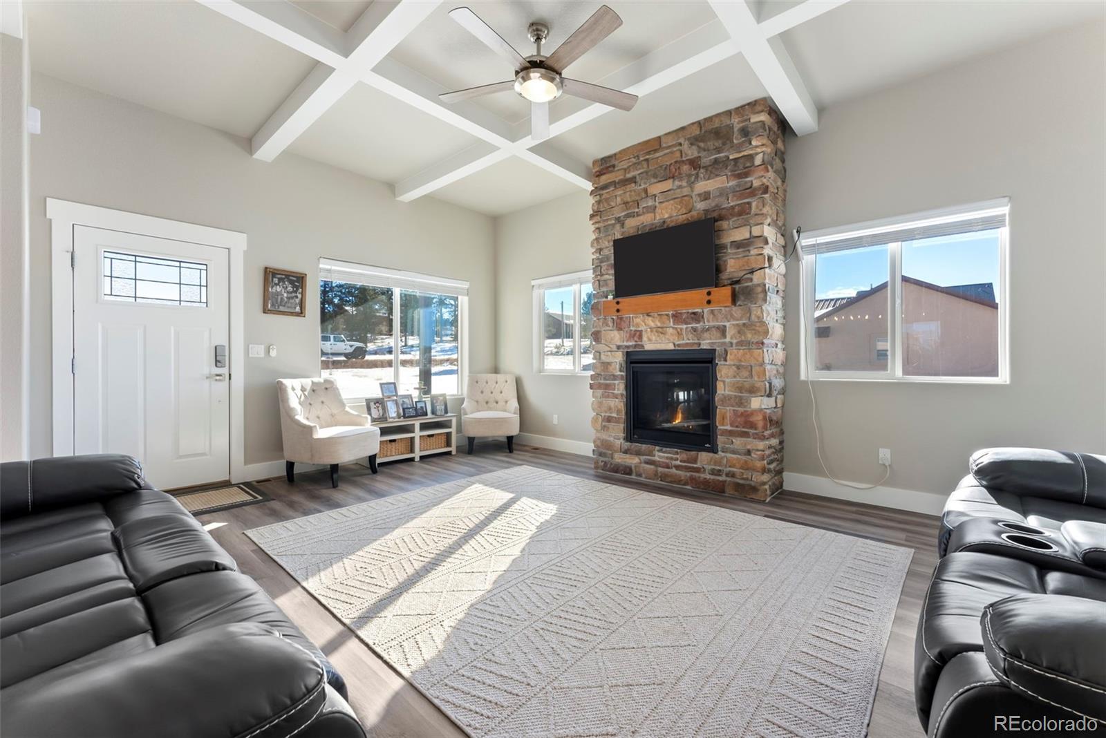489 Duesouth Road Florissant, CO 80816 - Photo 5 of 45 a living room with furniture a fireplace and a flat screen tv