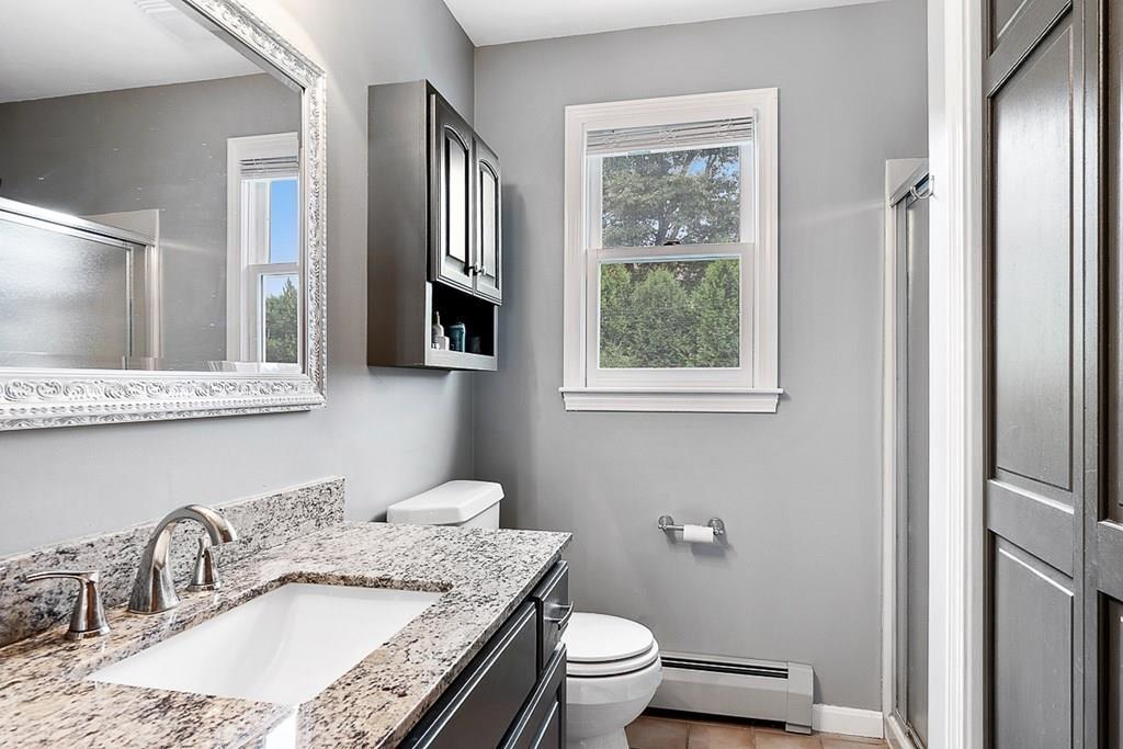 9 Bernard Road Rutland, MA 01543 - Photo 23 of 41 a bathroom with a granite countertop toilet a sink and a mirror
