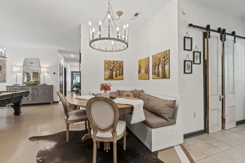 a room with pool table and windows