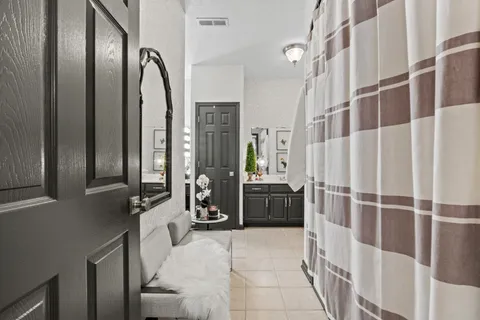 a bedroom with a bed and a large window