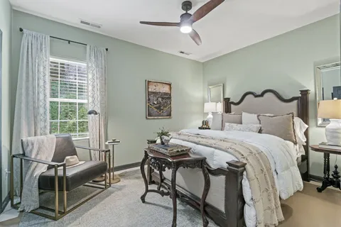 a front view of a house with garden and sitting area