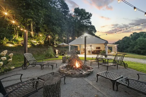a backyard of a house with table and chairs