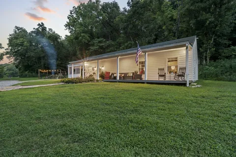 a room with pool table and chandelier